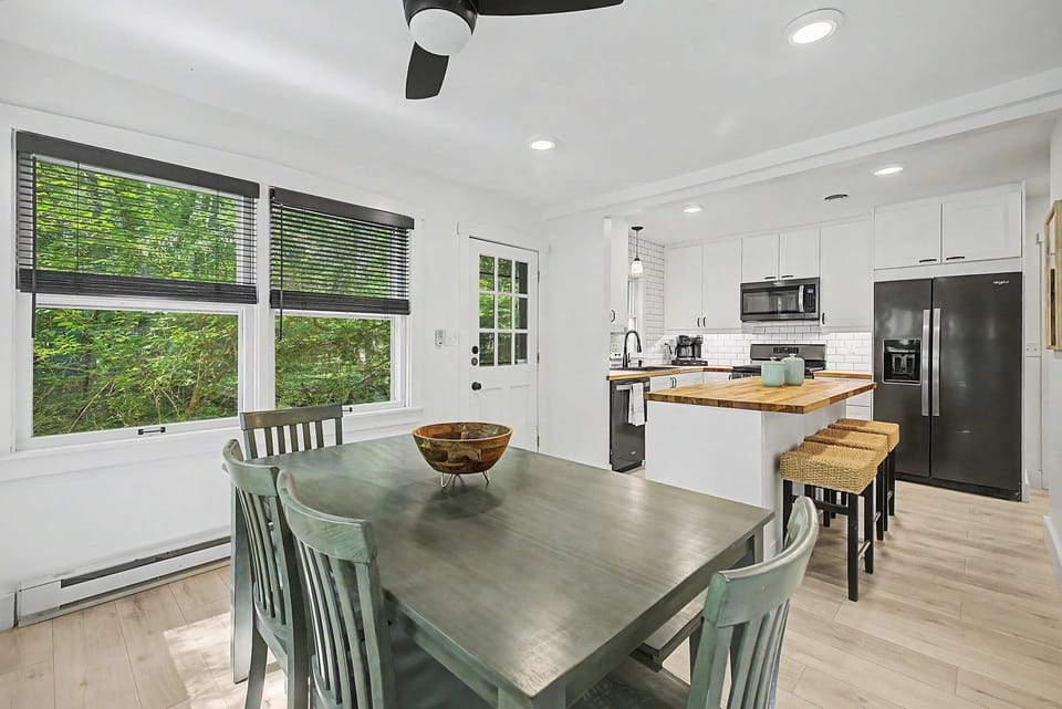 Kitchen island and dining table provide seating for the whole group.