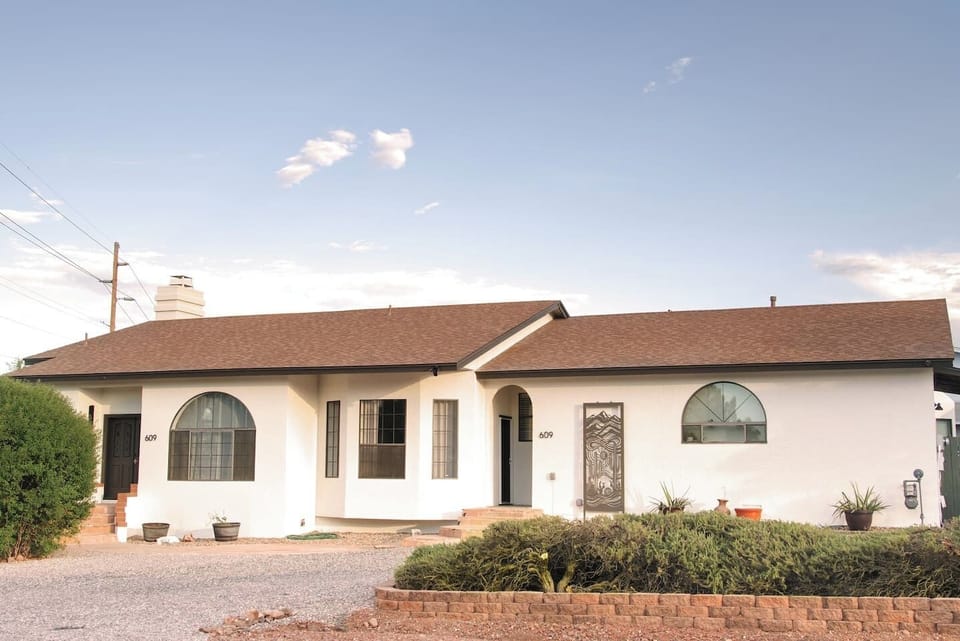 Pull up and feel instantly at home — the classic adobe-style exterior with arched windows gives your group a proper welcome from the moment you arrive.