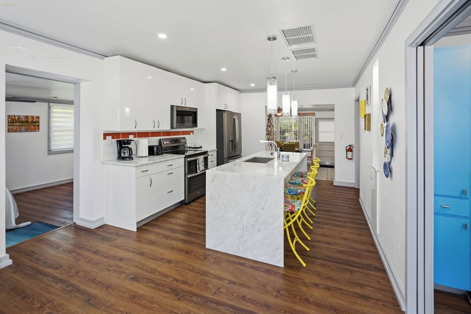 Bright modern kitchen with large island and colorful bar seating