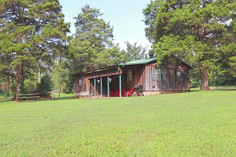 Our cozy Greers Ferry cottage - complete with front porch, back patio, firepit, and a huge yard!