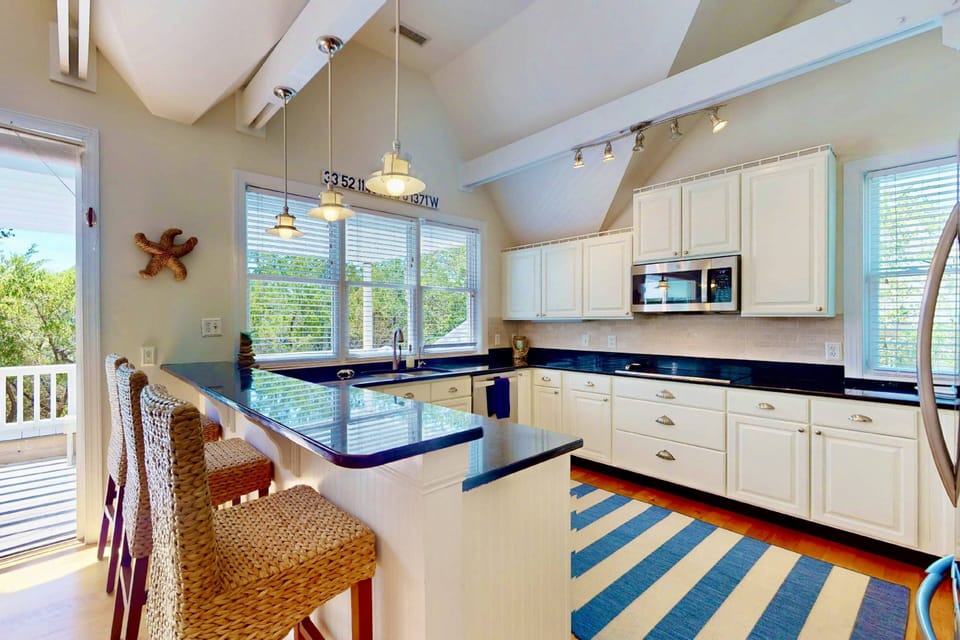 The fully equipped kitchen includes two ovens, an induction cooktop, and everything needed to prepare family meals
