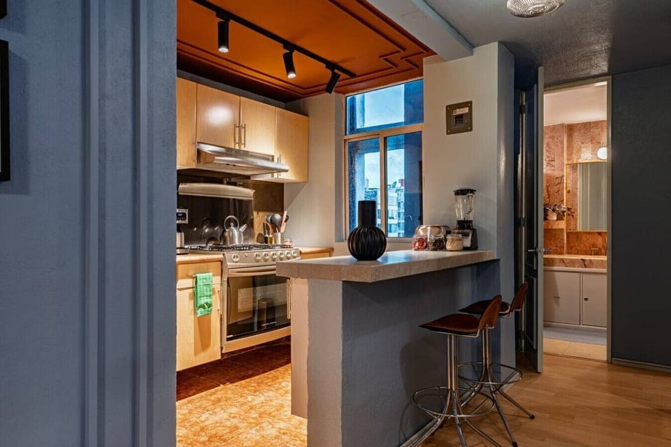 Fully equipped kitchen with essential appliances and a convenient breakfast bar.