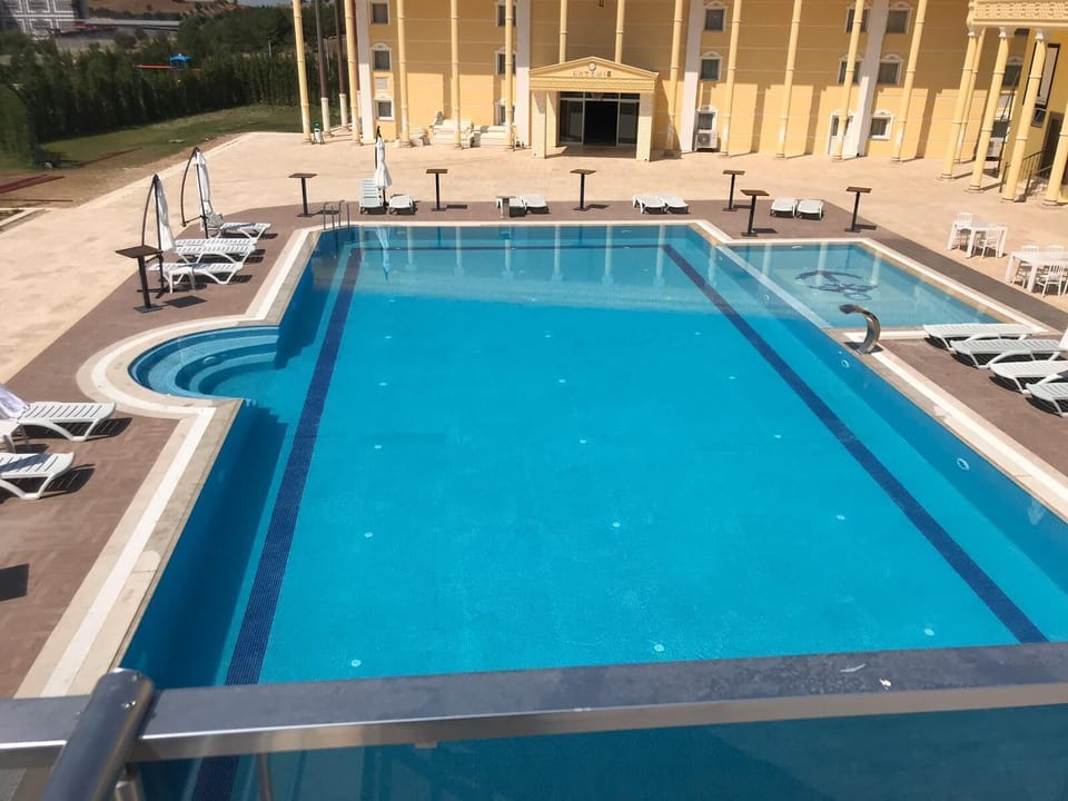 Seasonal outdoor pool, open 8:00 AM to 6:30 PM, pool umbrellas
