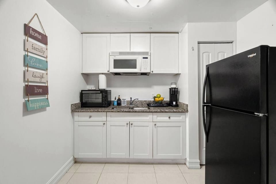 Fully equipped kitchenette ideal for quick meals or long stays- with toaster oven, regular toaster, coffee maker, hot plate, rice maker, and blender