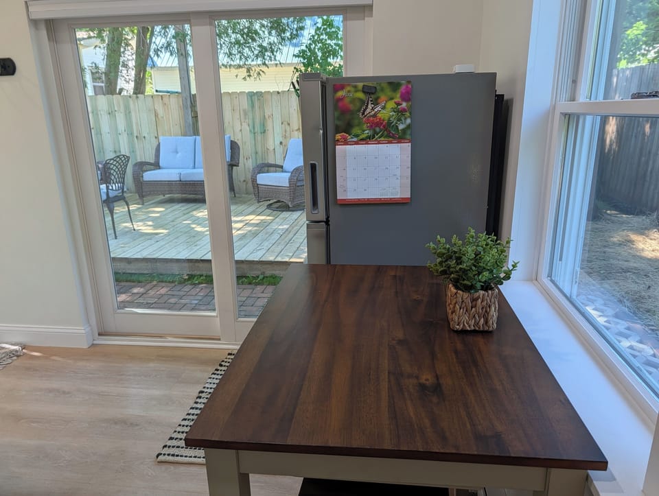KITCHEN: The view from the accommodating kitchen and cute dining table out to the fantastic fenced-in backyard