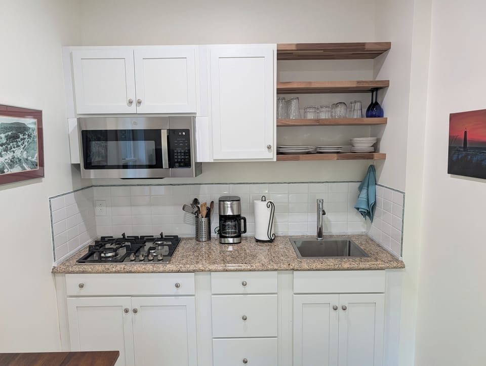 KITCHEN: The apartment's cute kitchen with a stove, microwave, coffeemaker, refridgerator, and other kitchen essentials. Perfect for cooking!