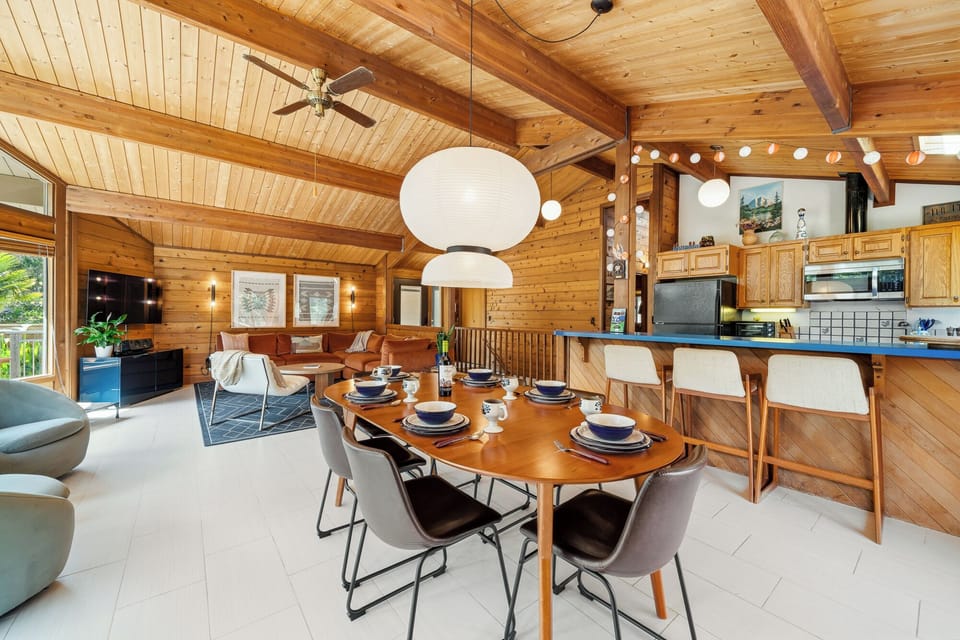Open living room with large comfy couch, Smart TV, Dining area, and open to the Kitchen.