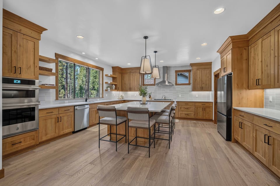 You'll love gathering in this spacious kitchen, where warm wood cabinetry and natural light create the perfect spot to cook, share meals, and make memories with your favorite people.