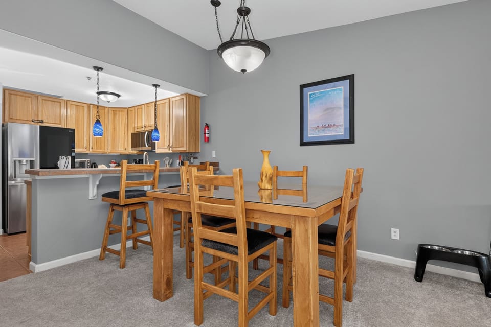 Gather around this inviting dining table where your mornings start with laughter and evenings end with stories. The open-concept kitchen flows seamlessly, making every meal a shared experience in your home away from home.