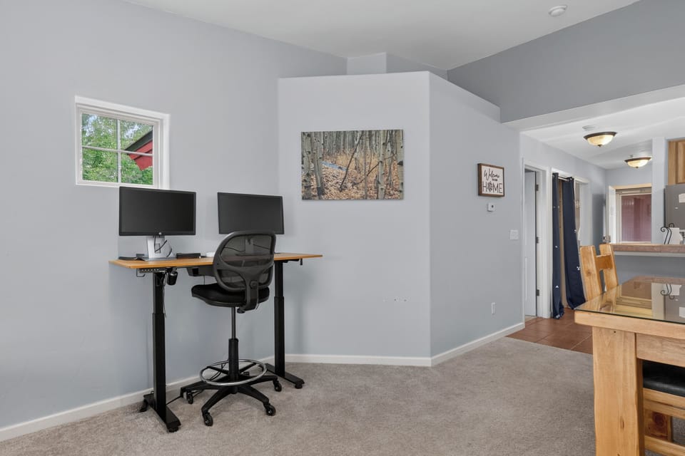 Your dedicated workspace awaits with natural light and dual monitors, offering the perfect blend of comfort and productivity for remote work or planning your daily adventures.