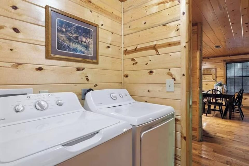 Your laundry area features a full-size washer and dryer tucked into warm knotty pine walls, making it easy to keep fresh during your stay.