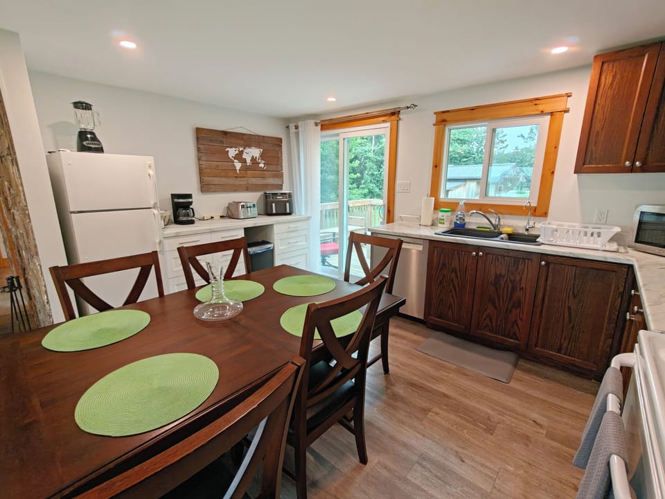 Bright kitchen-dining space with deck access and seating for four
