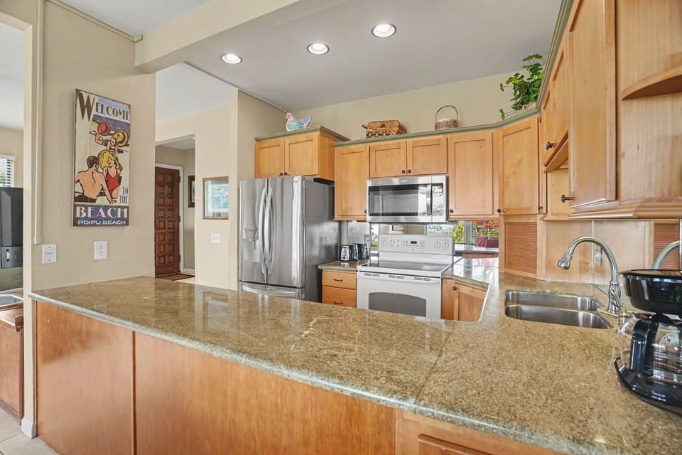 Your spacious kitchen features granite countertops, stainless steel appliances, and plenty of cabinet storage—perfect for preparing meals and gathering with family.