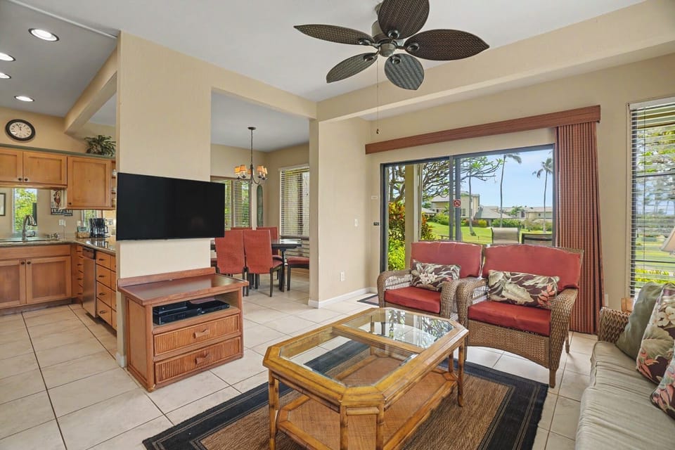 Relax in this breezy open-concept space with a fully equipped kitchen, cozy seating, and tropical garden views framing the room—your perfect island retreat.
