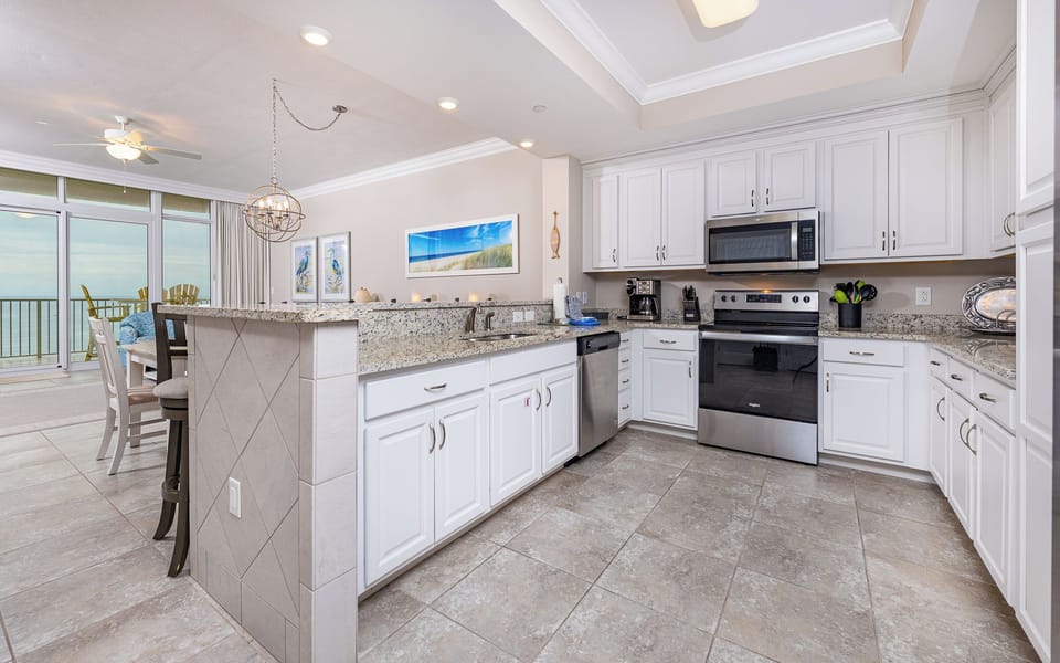 Smooth granite counters invite you to prepare family meals while hearing the distant shore from the kitchen sink