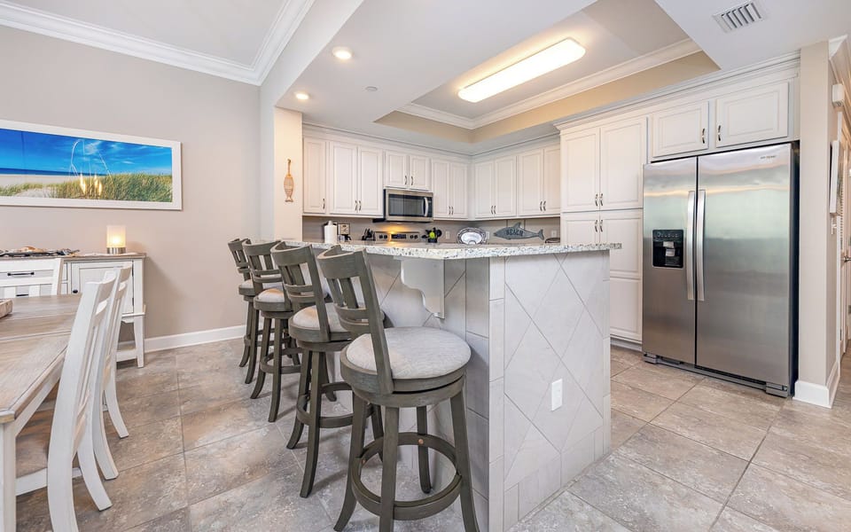 Gather around the breakfast bar in this kitchen as you share stories while meals simmer nearby