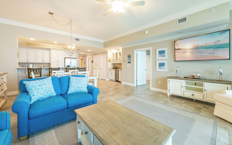 Your living room offers cozy seating to unwind while watching your favorite shows on the large wall TV