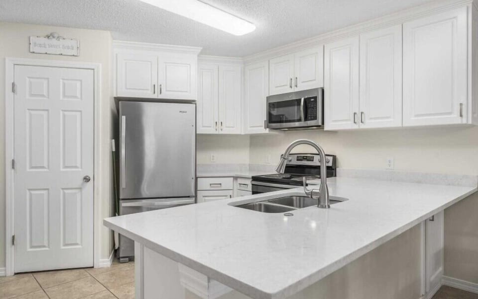 Modern kitchen featuring ample counter space, updated cabinetry, and convenient breakfast bar seating.