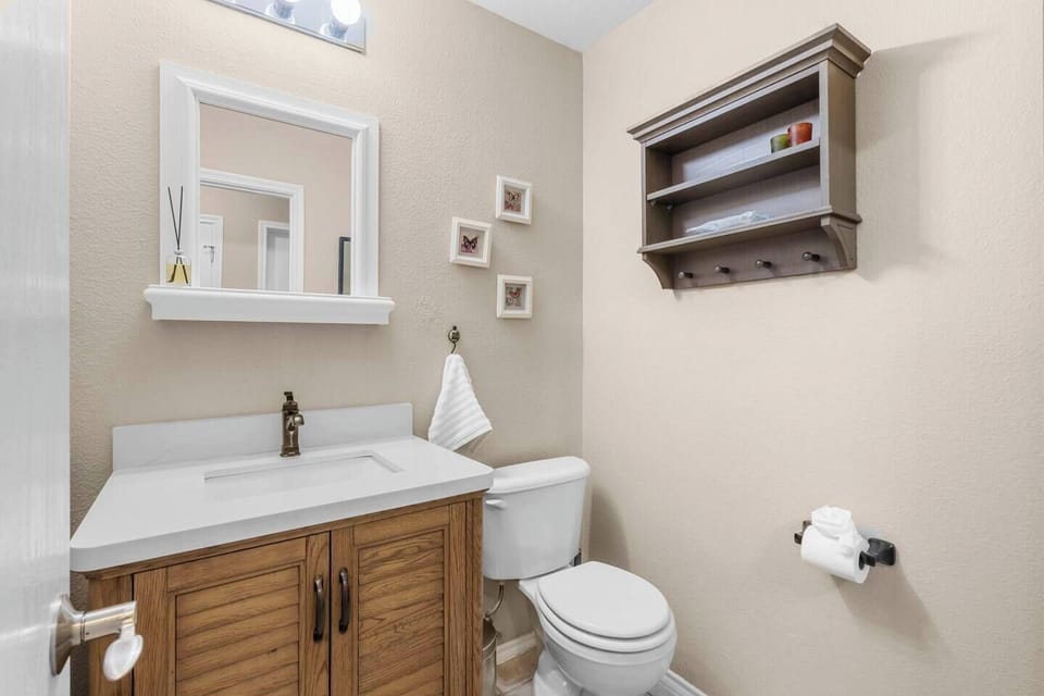 Convenient half bath featuring a stylish wooden vanity.
