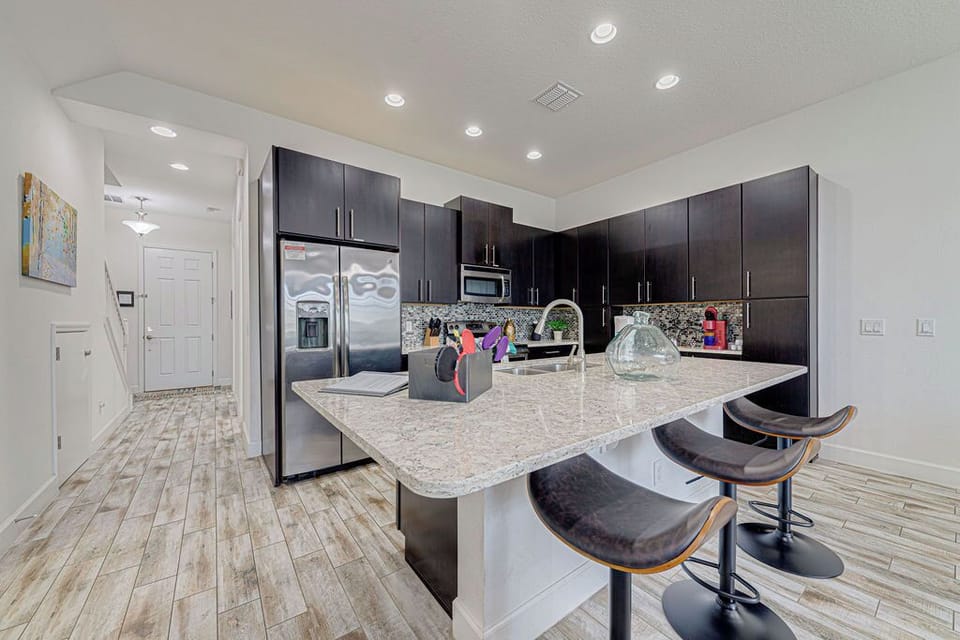 Kitchen - fully stocked with cookware, utensils, plates, cups, bowls.