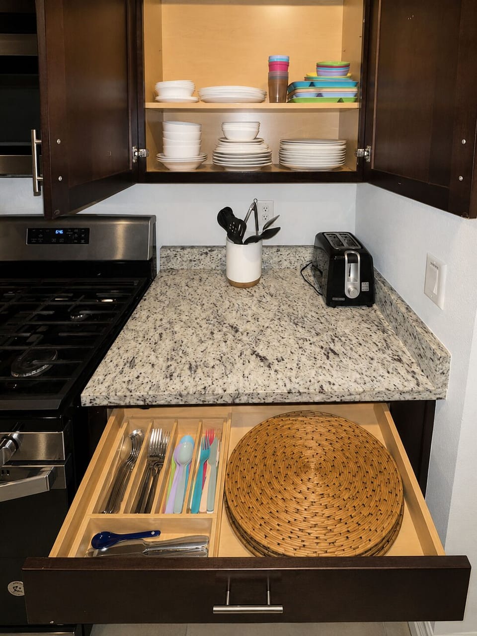 Fully stocked with plates, dinnerware, silverware, and placemats.
