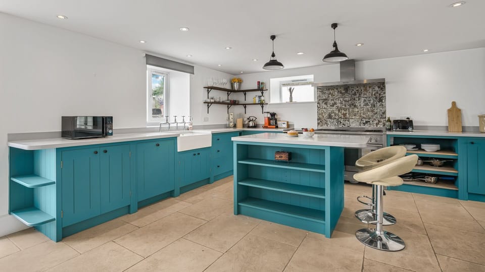 The spacious kitchen has all appliances, large kitchen island and a breakfast table