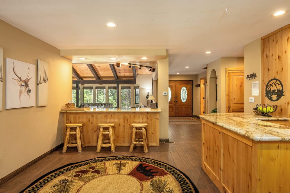 You'll love the warm, rustic charm of this inviting kitchen and dining space, where natural wood and mountain-inspired accents create the perfect setting for your morning coffee or evening gatherings.