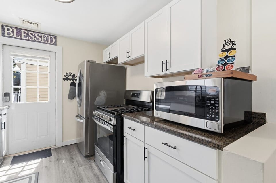 Start your day right at the provided coffee station in this fully stocked modern kitchen, boasting stainless steel appliances and an in-unit washer and dryer for a hassle-free stay.