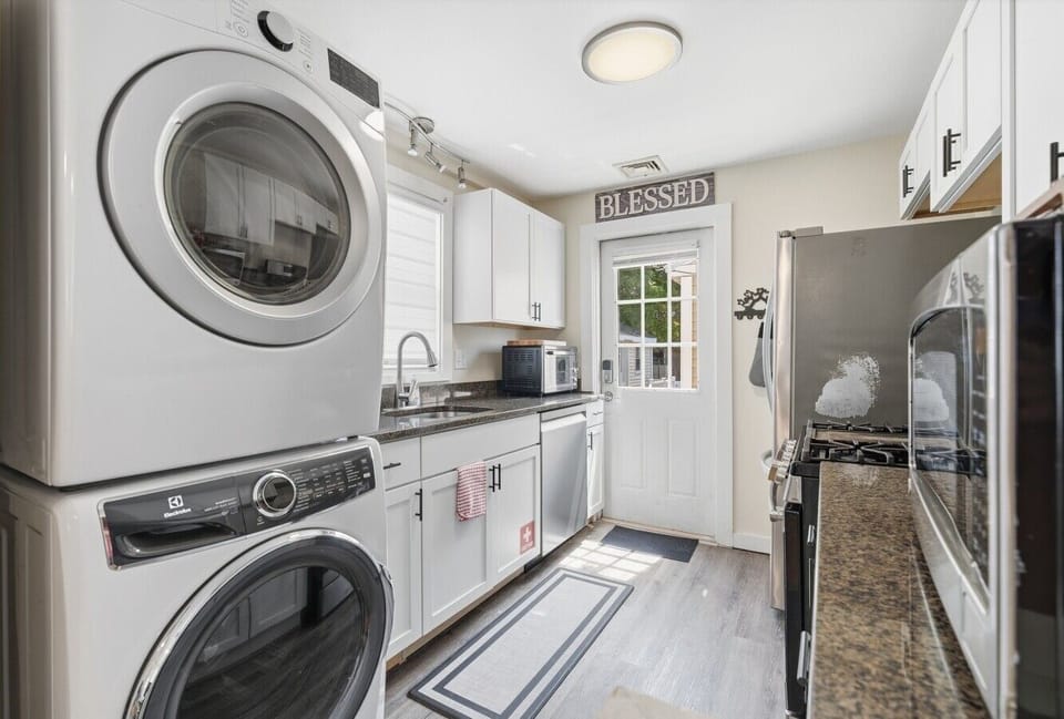 Enjoy a seamless experience in this bright, open-concept kitchen that flows perfectly into the living area, complete with a gas range, dishwasher, and convenient laundry tower.