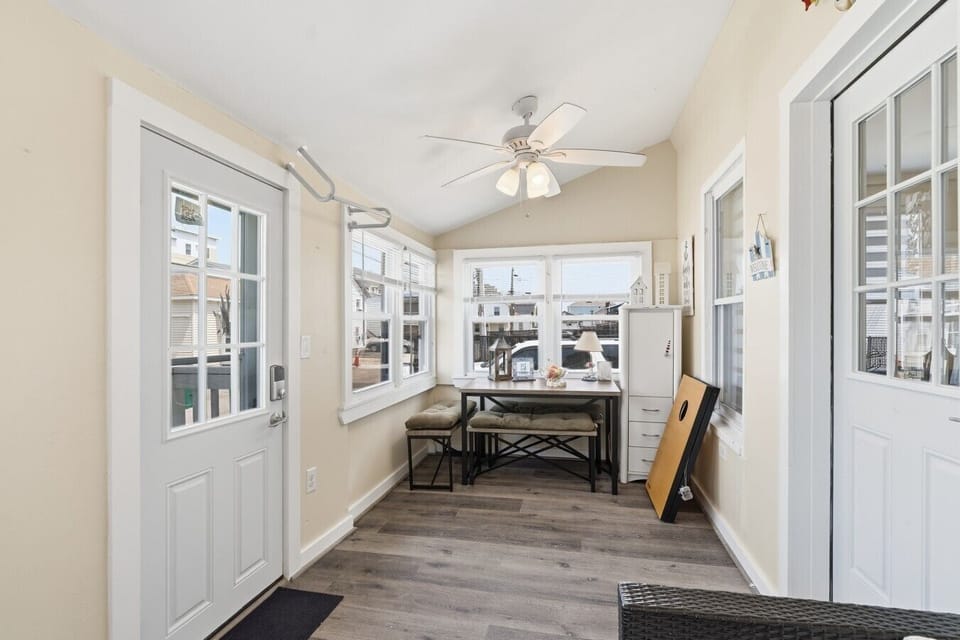 Welcome to your getaway; enter through the bright, enclosed front sunroom, complete with a cozy seating area and keyless entry to the main living space.