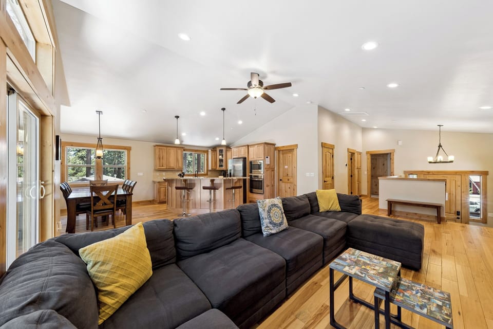 Sink into this plush sectional and feel the space open up around you—soaring ceilings, warm wood tones, and abundant natural light create a welcoming retreat for unwinding after your adventures.