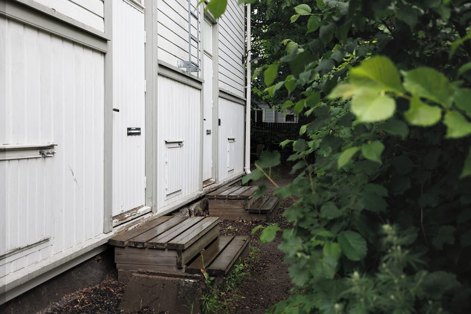 Private exterior entry with leafy walkway and charming wood steps