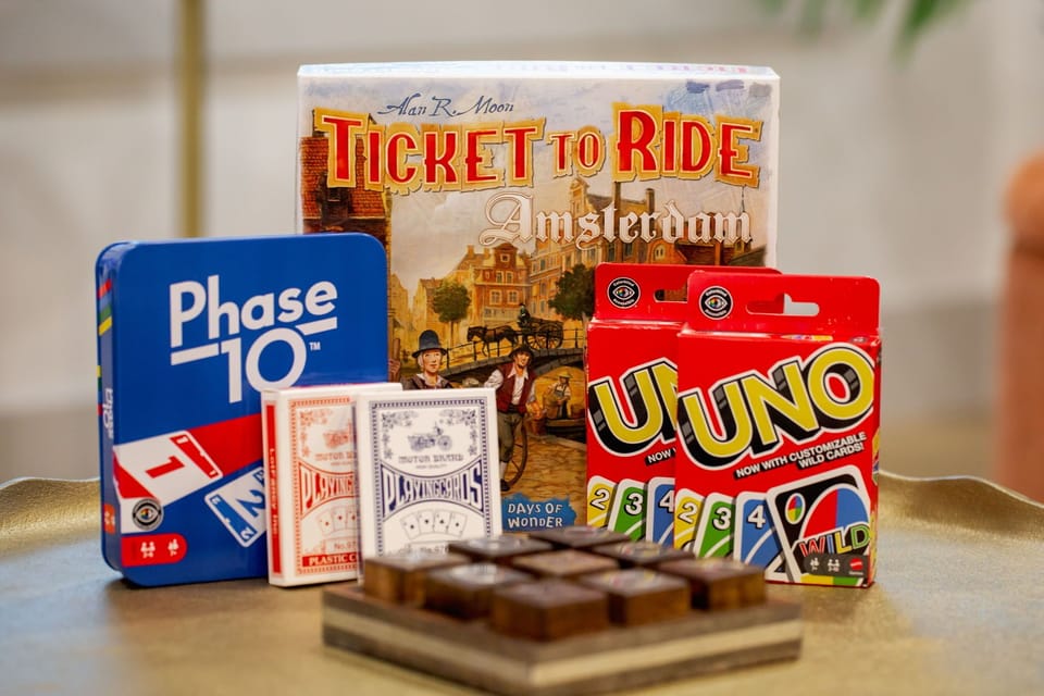 🎲 Game collection ready for endless fun! Ticket to Ride, UNO, Phase 10, tic-tac-toe, and classic playing cards. 🃏 Everything you need for the perfect game night in. Pick a favorite and let the friendly competition begin at SoCo Oasis! 😄