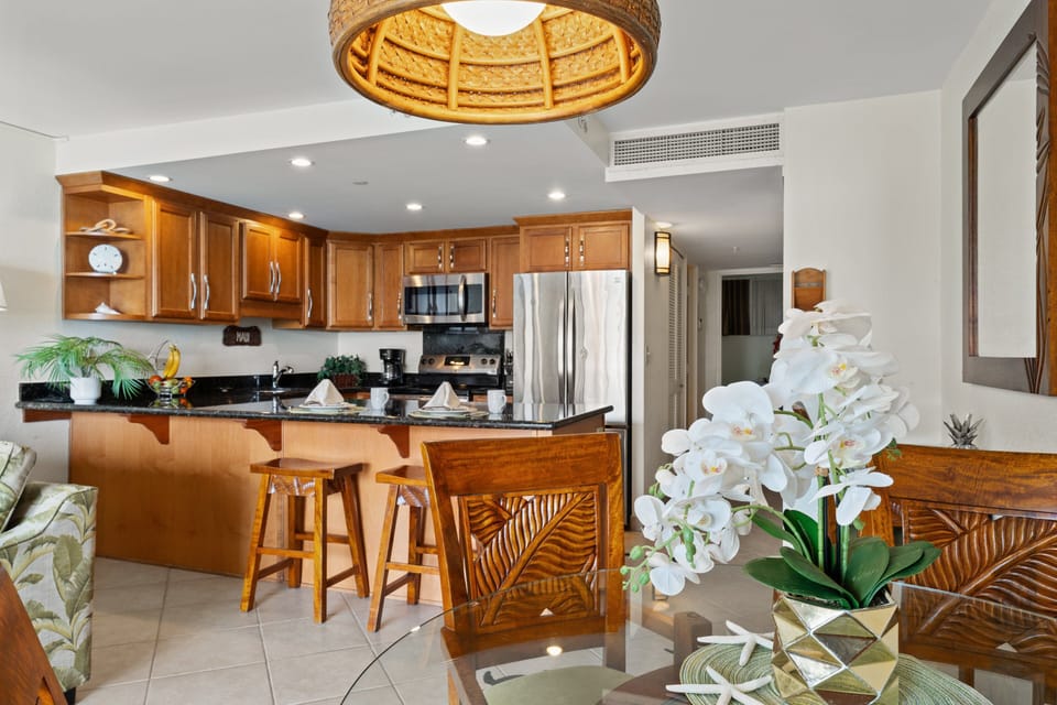 Kitchen with breakfast bar seating and adjoining dining area.