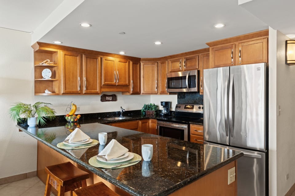 Fully equipped kitchen with granite counters and stainless appliances.