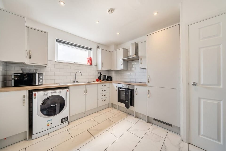 Second stylish kitchen ready for group cooking with full appliances