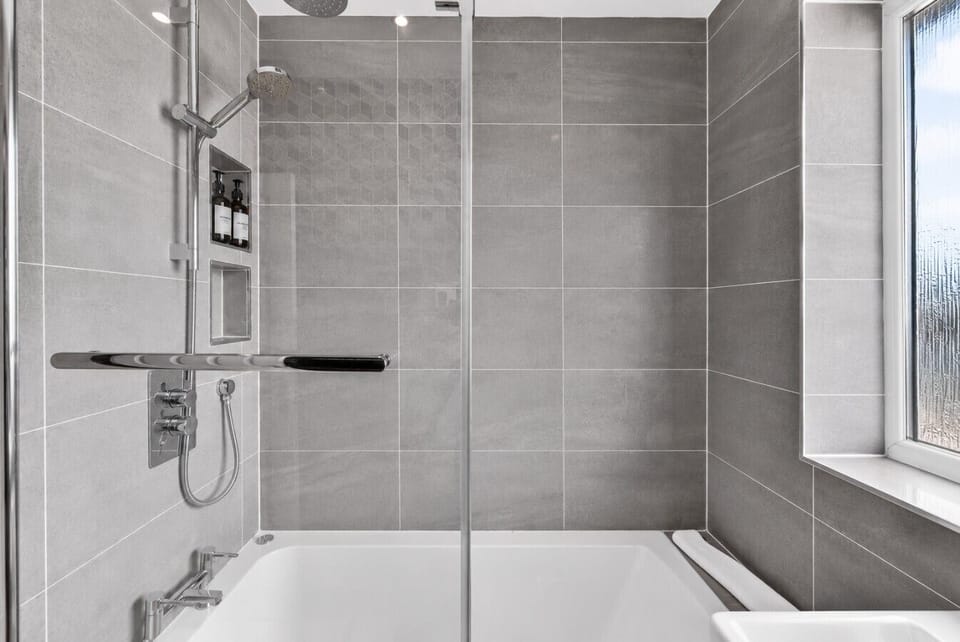 The modern bathroom features a shower over the bath and complimentary toiletries for your convenience.