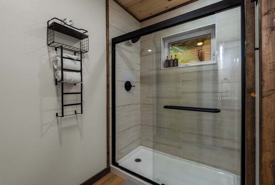 Enjoy a spacious walk-in glass shower featuring modern finishes and a clean, spa-inspired design.