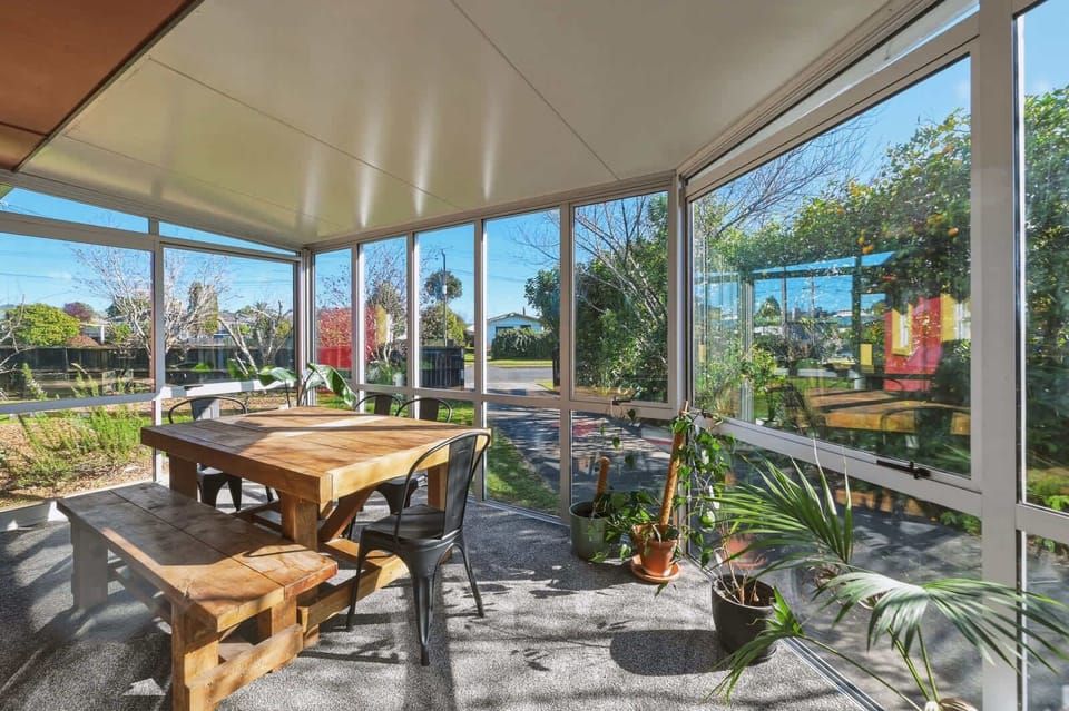 Glass sunroom with timber table