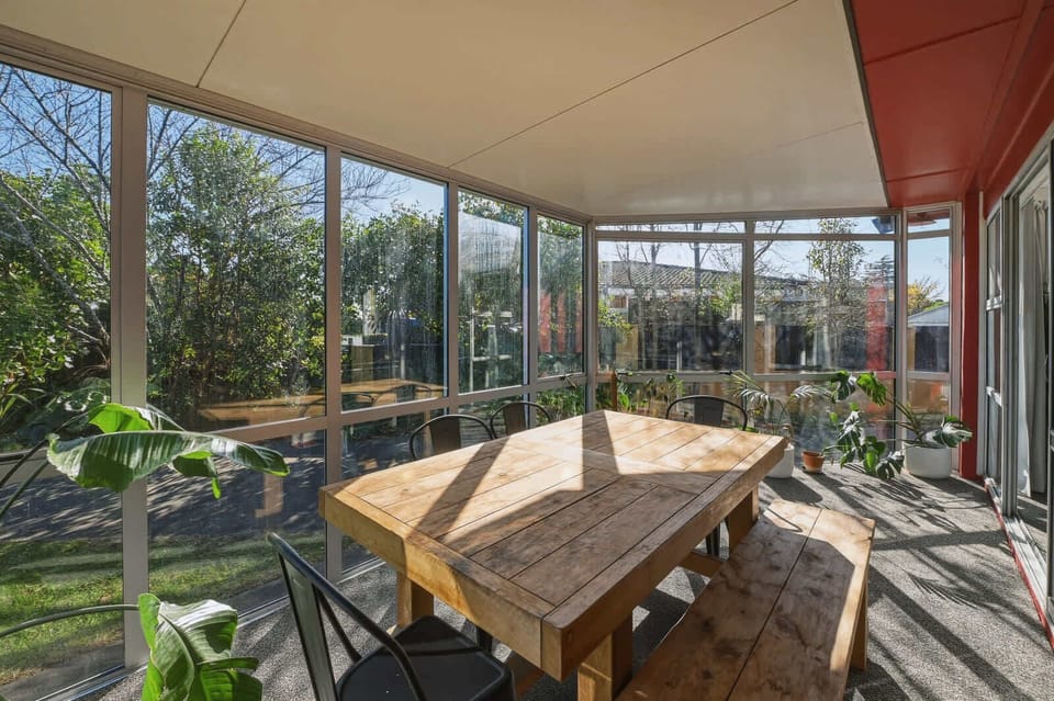 Sunroom dining with garden views