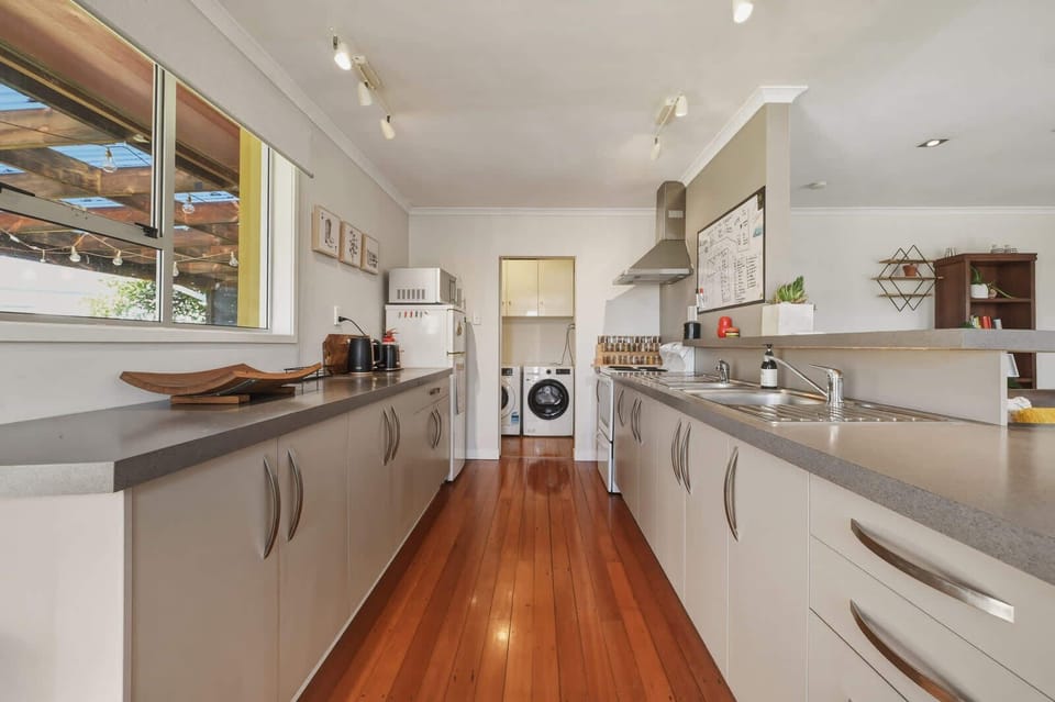 Galley kitchen with laundry beyond