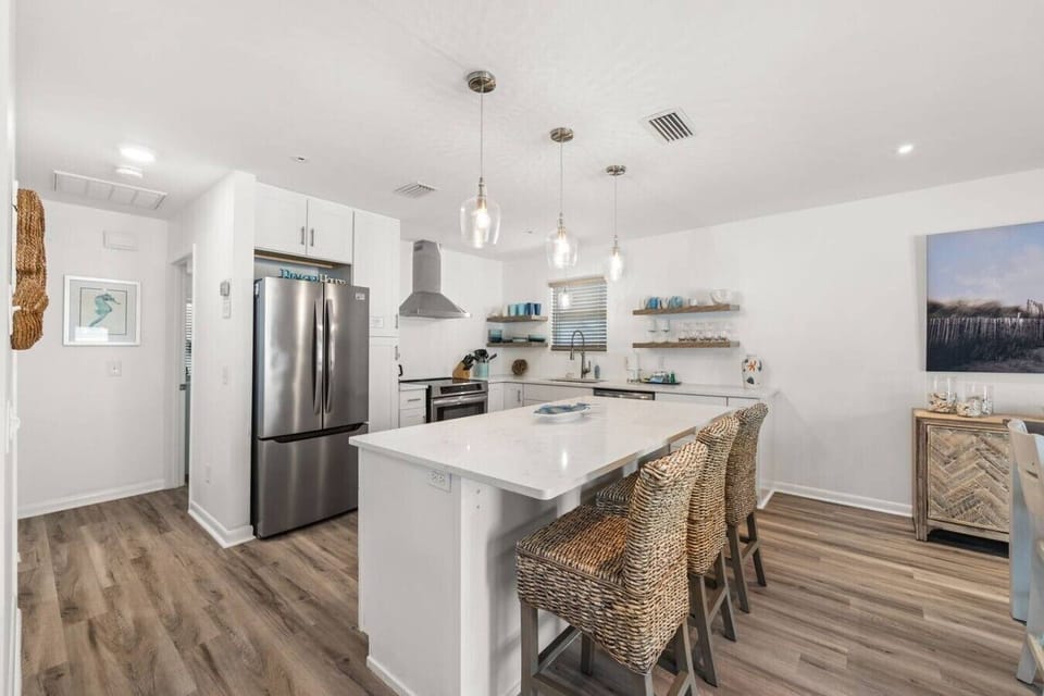 Fully updated coastal kitchen with oversized island seating and space to cook together.