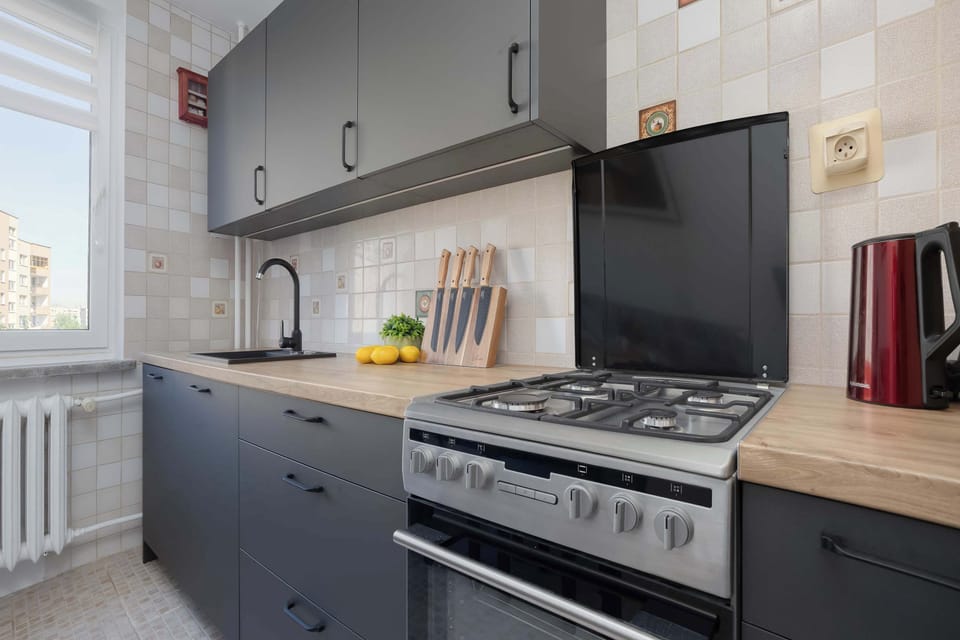 The kitchen's sleek design includes all necessary cookware and utensils.