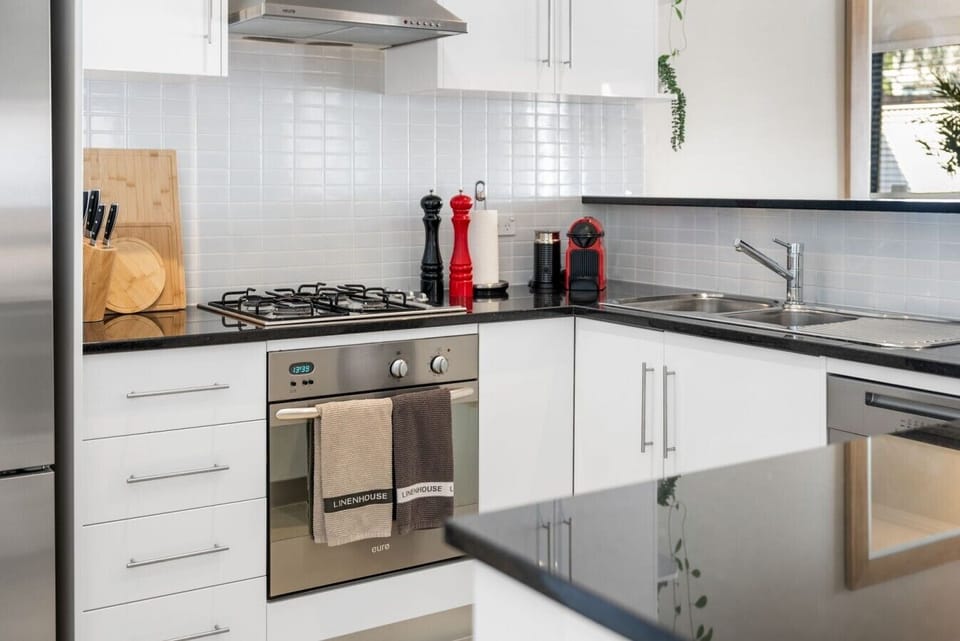 The upstairs bathroom includes a full-sized bath, separate shower and spacious vanity, making it ideal for families or groups.