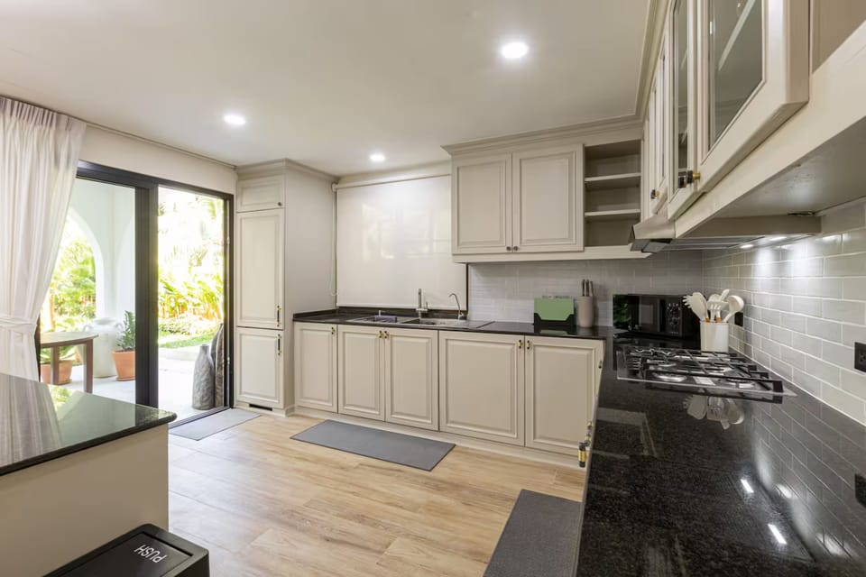 Four-Bedroom Holiday Home | Private kitchen | Fridge, microwave, cookware/dishes/utensils, dining table