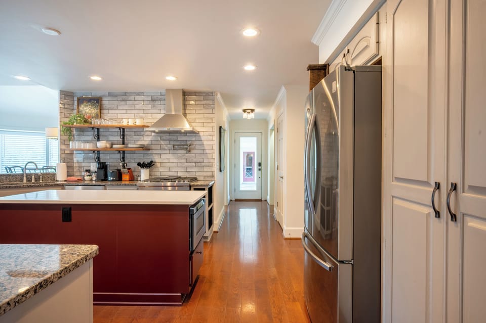 Fully equipped kitchen featuring stainless steel appliances, ample counter space, and a large island—perfect for cooking, dining, and gathering.
