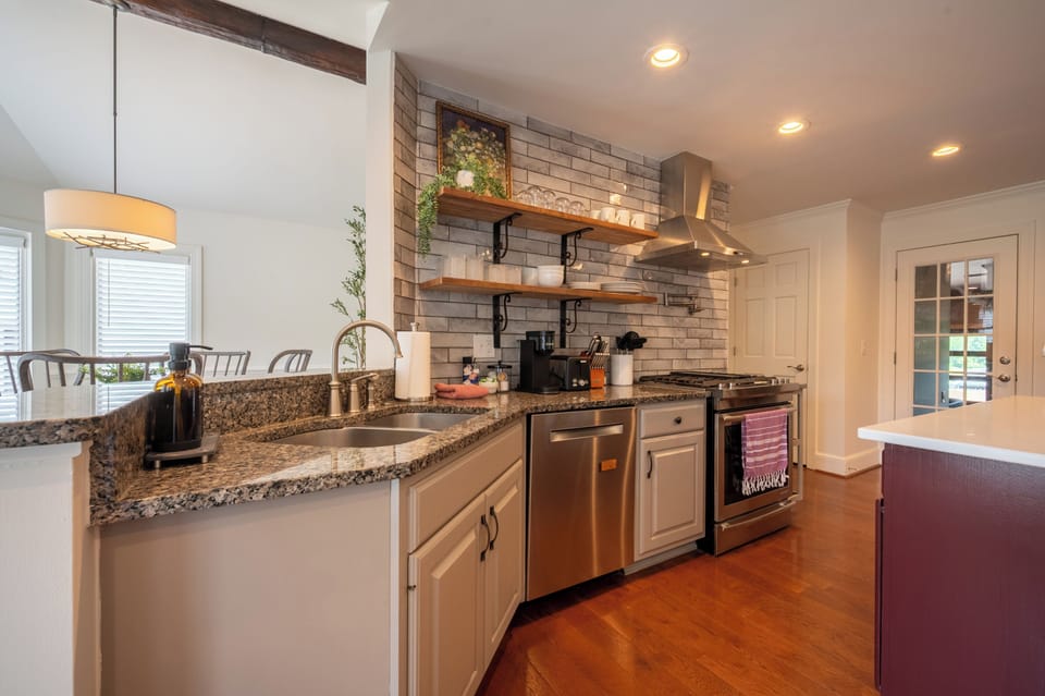 Modern kitchen with granite countertops, stainless steel appliances, and a spacious layout—perfect for cooking and gathering.
