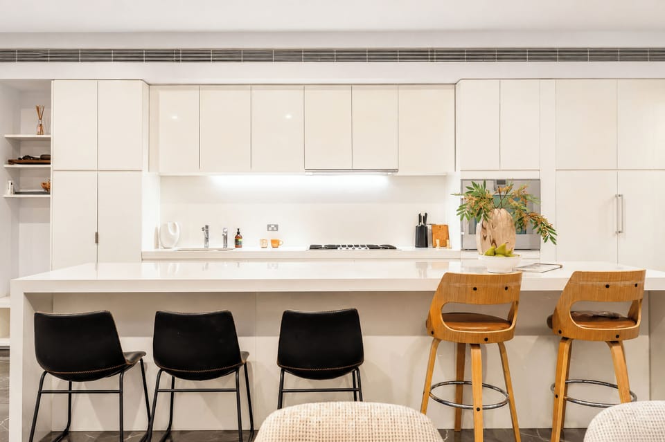 Bright designer kitchen with oversized island and stylish bar seating