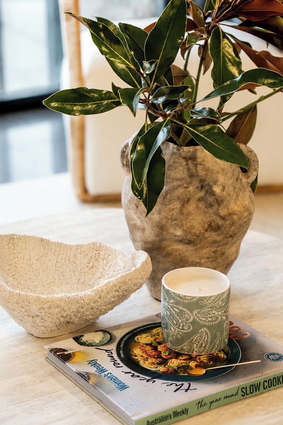 Styled décor corner with greenery, candlelight, and warm designer touches
