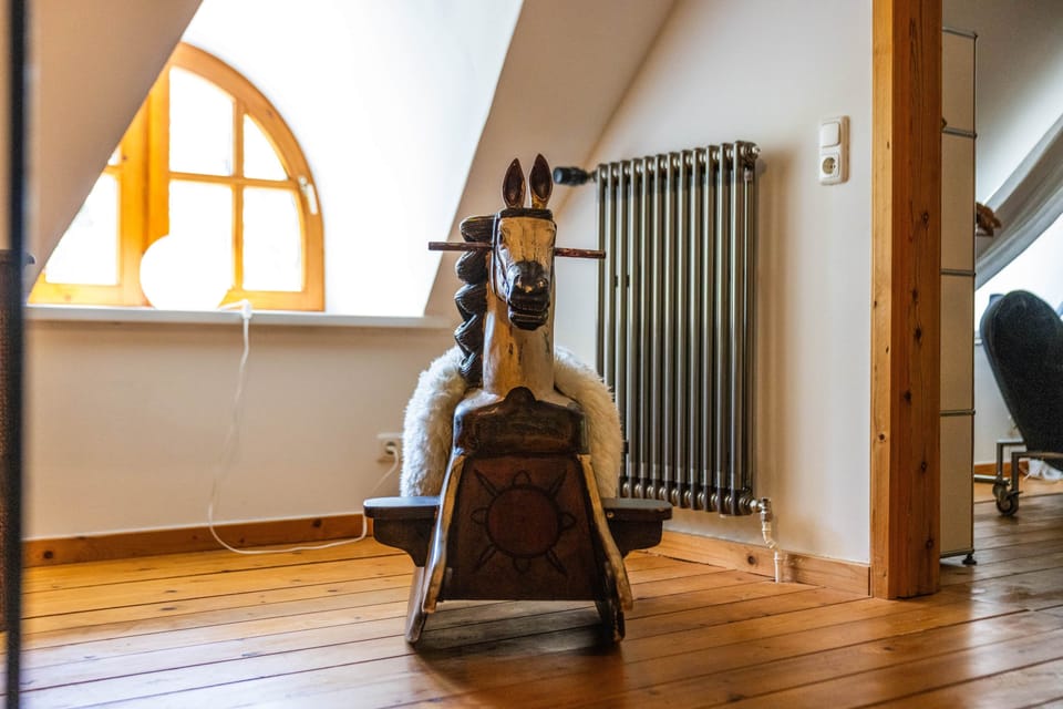 Rocking horse by the arched window